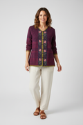 Woman wearing Gudrun Sjödén burgundy embroidered organic cotton cardigan