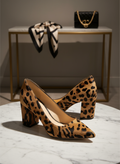 Vince Camuto Leopard Print Block Heel Pumps in elegant setting